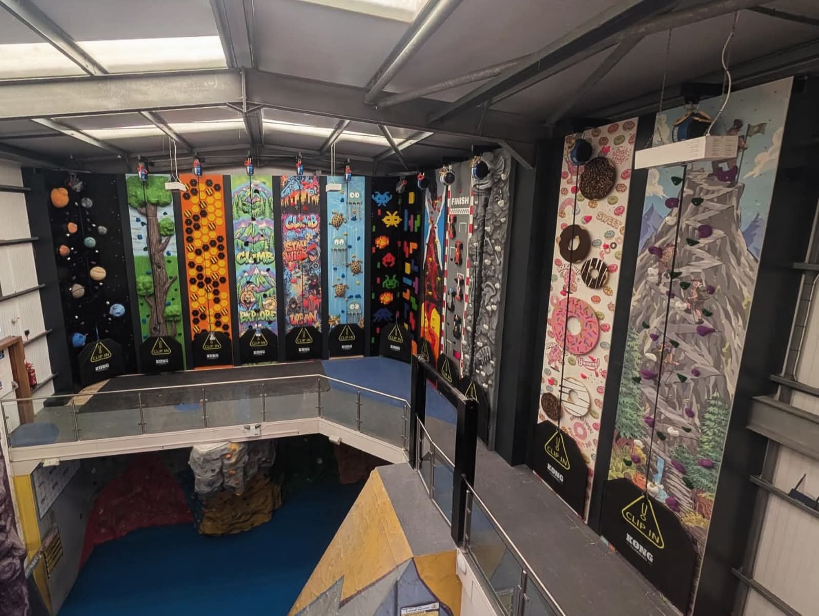12 Climbing Walls next to each other of different themes with auto-belay device